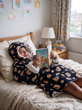 Hugsy Kids Teddy Bear Black wearable blanket hoodie, reading in bed